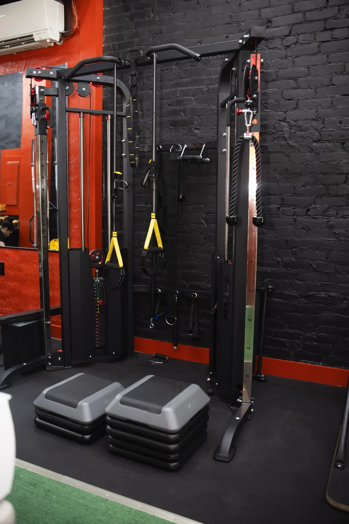 Cable station and step platforms against black brick and red trim